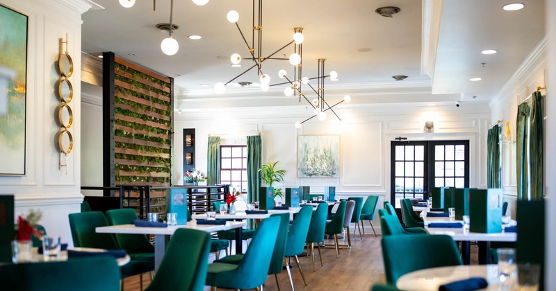 Interior, wide view of dining area, tables ready for guests