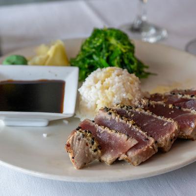 Sesame seared ahi tuna with sicky rice, sauce and wakame salad.