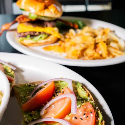 Avocado toast served with a Burger with fries in the background.