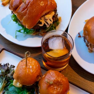 Old Fashioned cocktail and various food.