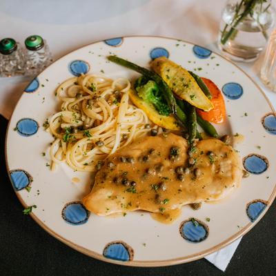 Chicken sauteed in caper sauce, served with pasta and sauteed vegetables