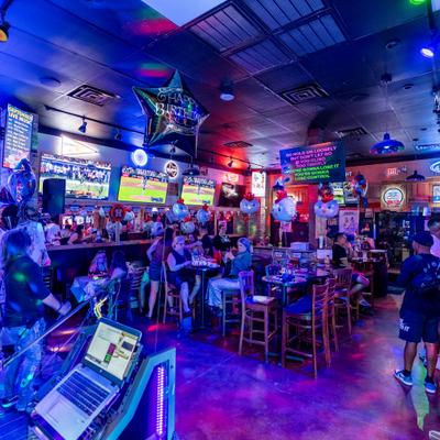 Interior, diner and bar area, guests, bar behind, screens above
