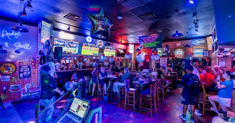 Interior, diner and bar area, guests, bar behind, screens above