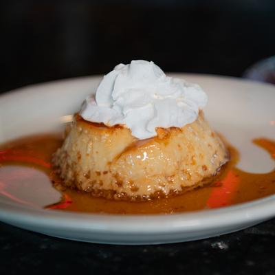 Flan, with whipped cream on top.
