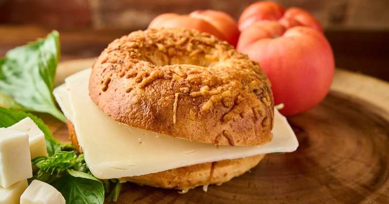 A cheese tomato bagel sandwich