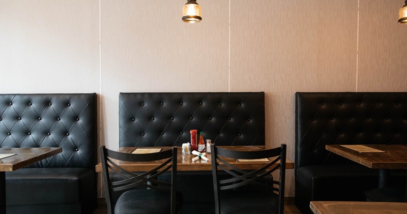 Boots beside the wall with tables and chairs
