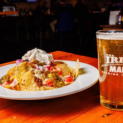 Traditional nachos and a glass of beer.