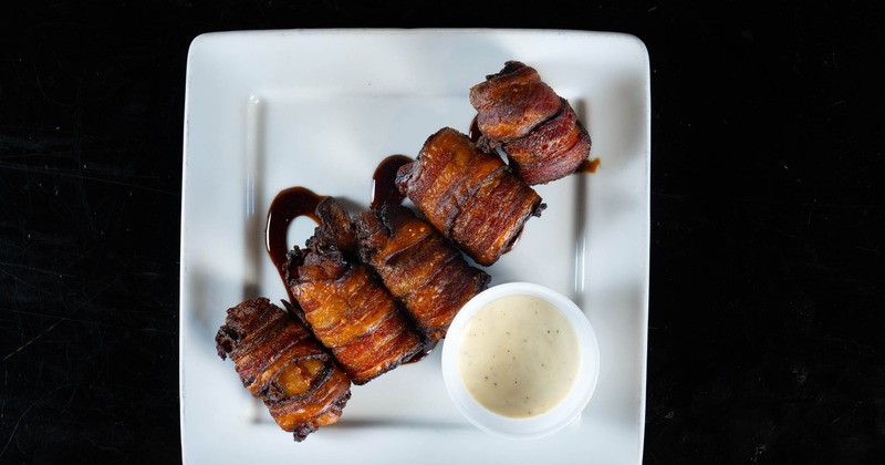 Bacon-wrapped jalapeno poppers with dipping sauce