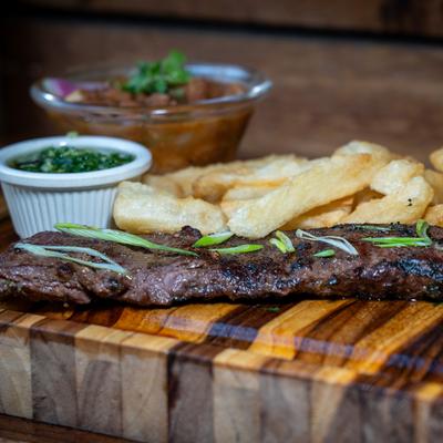 Skirt steak with yuca fries and dipping sauces.