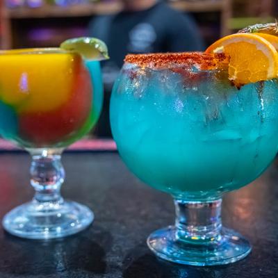 Colorful cocktails on a counter.