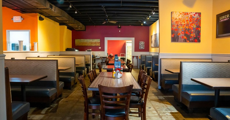 Interior of restaurant with tables, chairs and booths