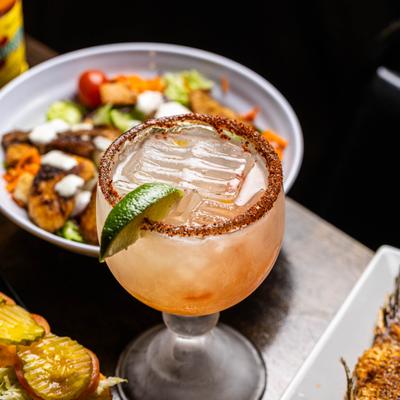 A margarita and meals on the table.