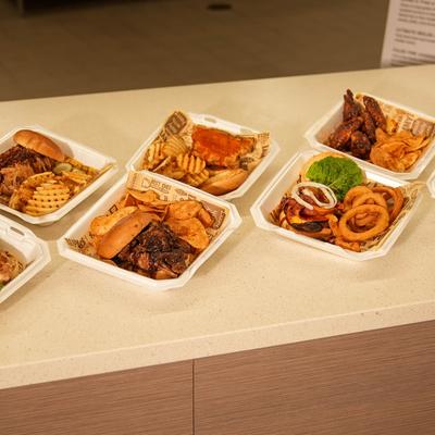 Variety of takeout meal containers filled with different meals.