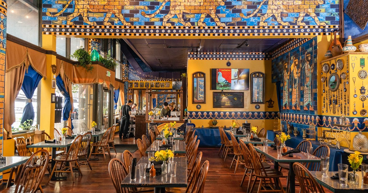 Interior, dining area, tables with chairs ready for guests, middle eastern motif decoration
