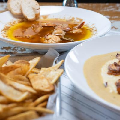 Shrimp soup served with chips and bread slices.