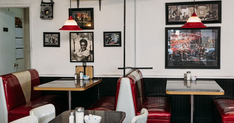 Interior, dining area, booths, walls decorated with retro pictures of American pop culture