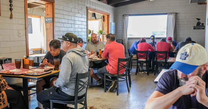 Interior with brick walls and wooden tables and chairs