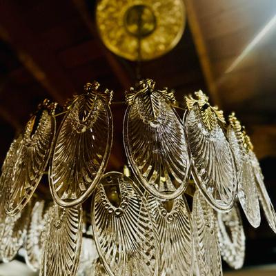 Interior detail, a crystal glass chandelier with leaf shaped prisms.