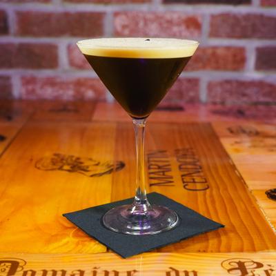 Espresso martini on a wooden table.