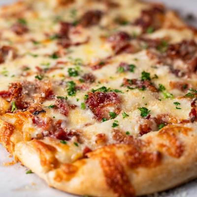 Garlic-cheese flatbread with bacon bits.