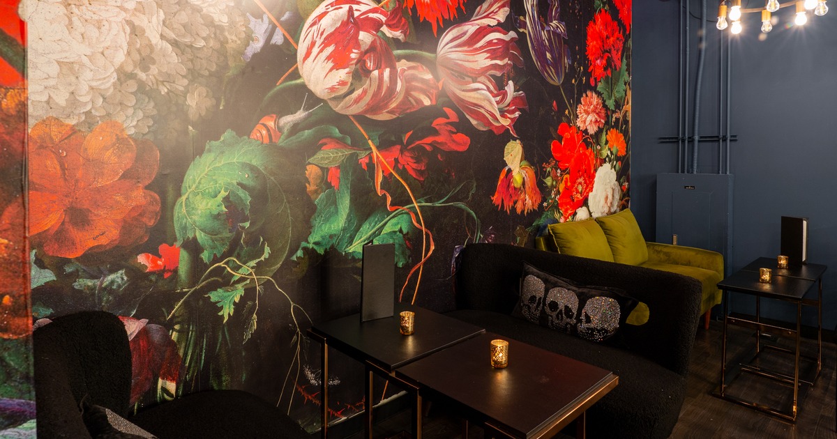 Table and chairs by painted wall