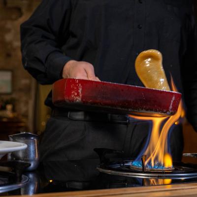 Staff cooking food in a pan, close up