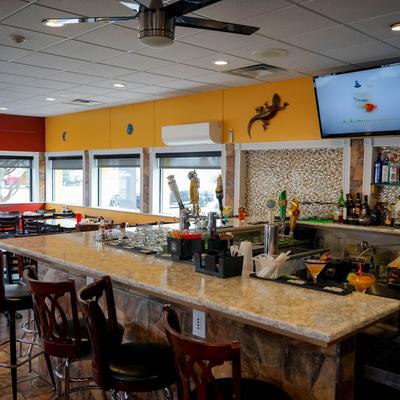 Bar with bar stools and big TV on the wall