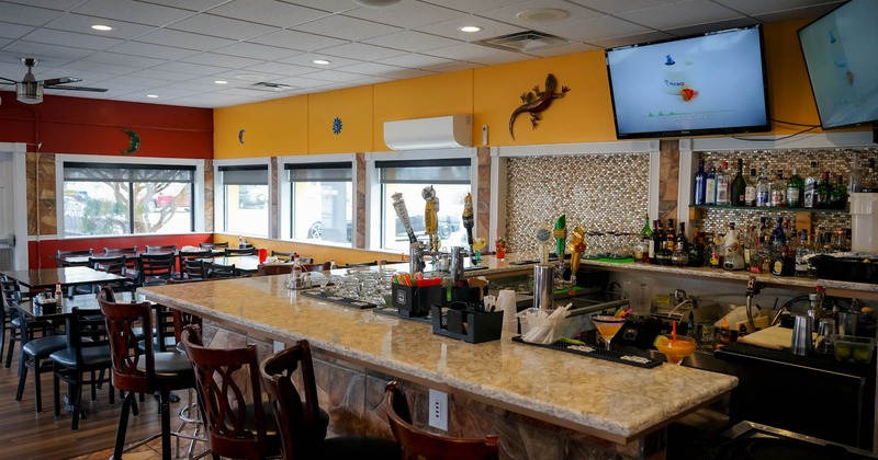 Bar with bar stools and big TV on the wall