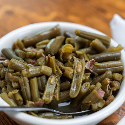 Bowl of classic Southern-style seasoned green beans, close-up.