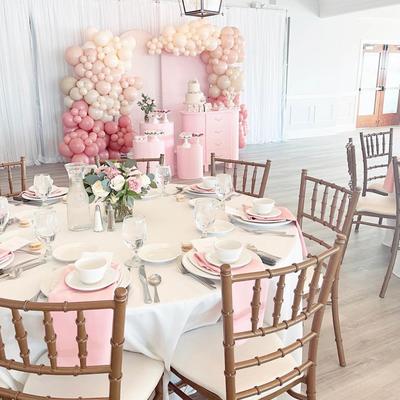 Pink balloon baby shower table setting.