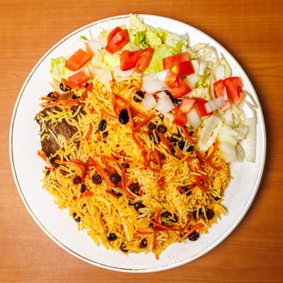 Pilaf wih meat and side salad, toped with shreded carrots and raisins.
