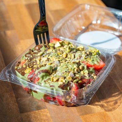 Strawberry Dubai chocolate topped with chopped pistachios.