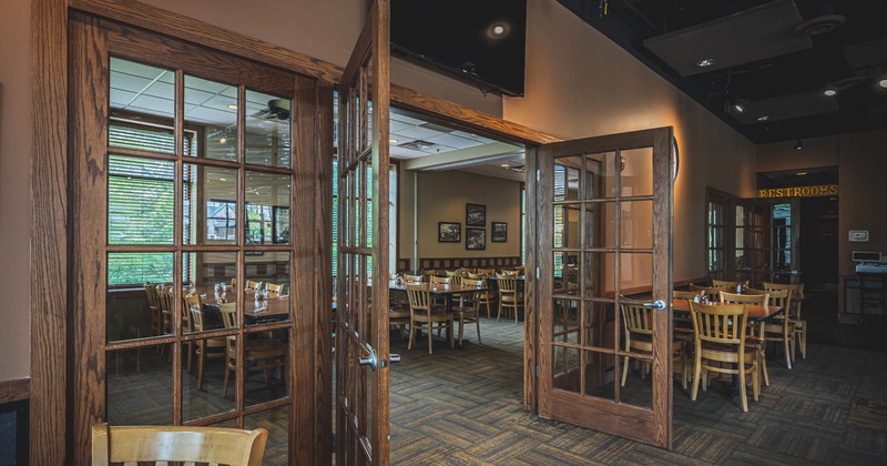 Interior, doorway between two rooms with dining tables