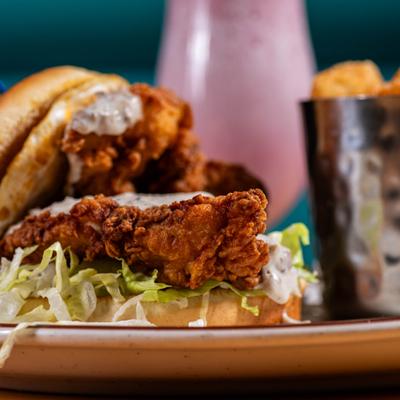 Fried chicken sandwich served with tater tots.