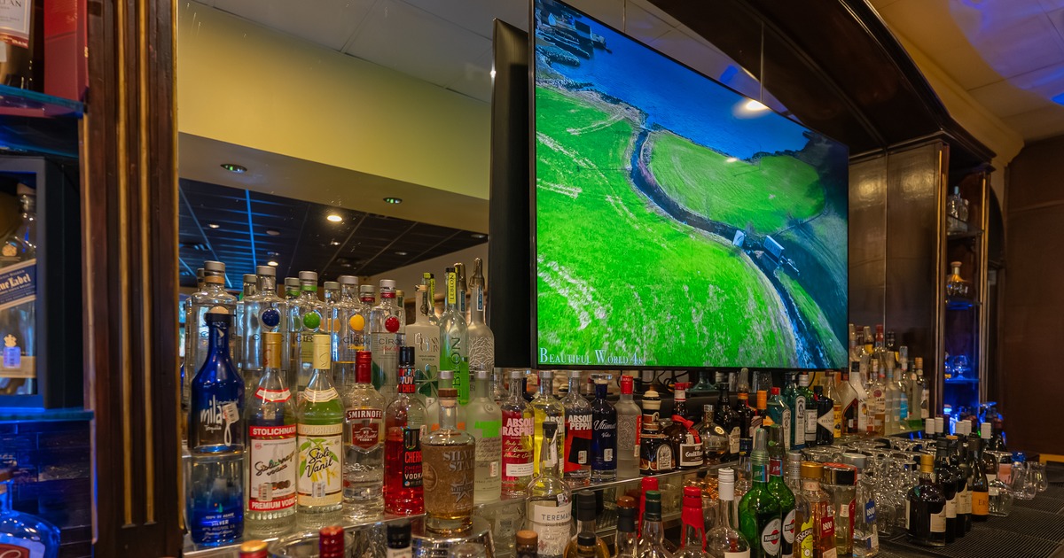 Drink rack above bar, tv screen