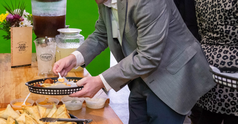 Guest taking food from carting table