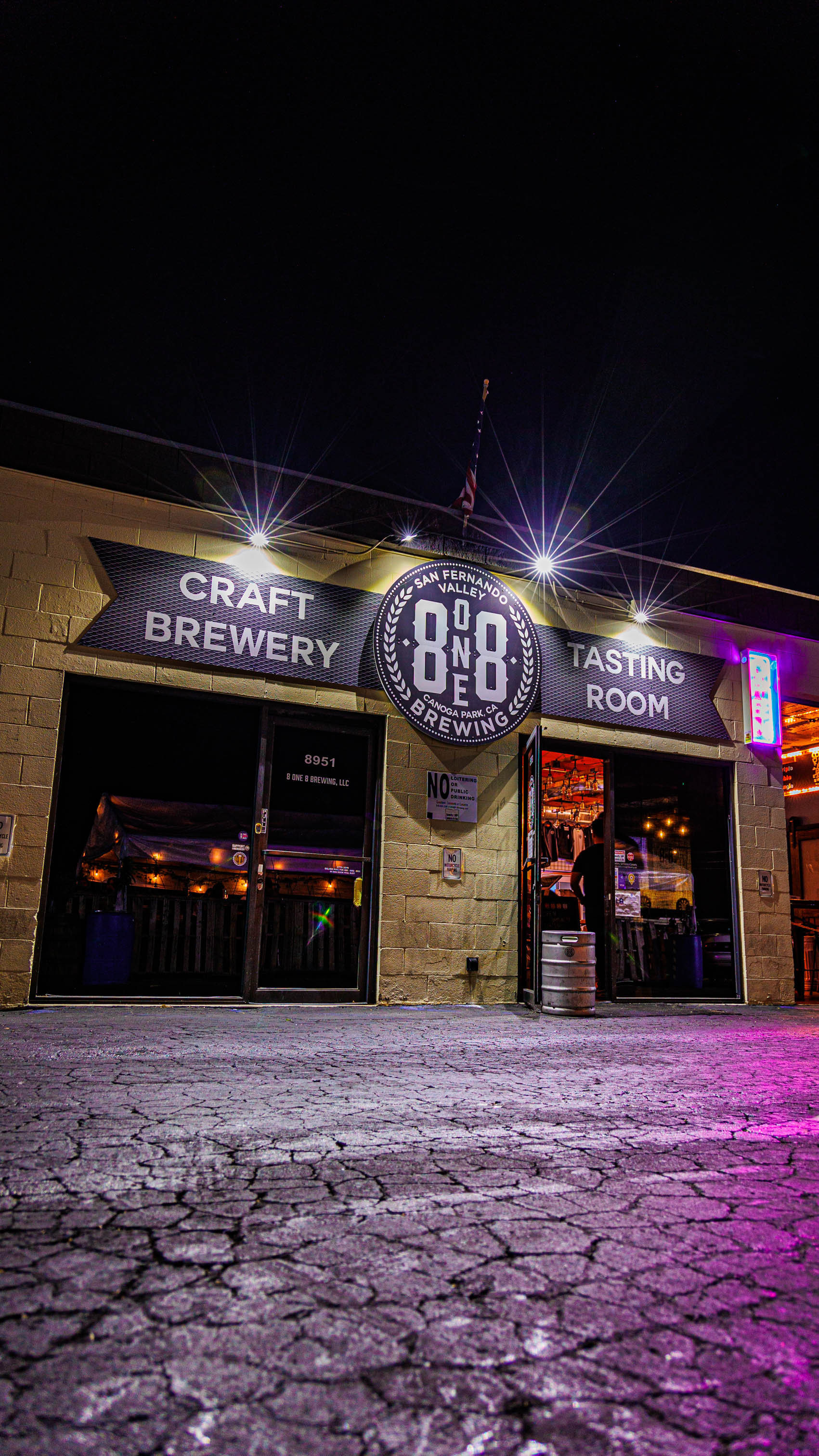 Storefront featuring warehouse-style seating with signage and entrance