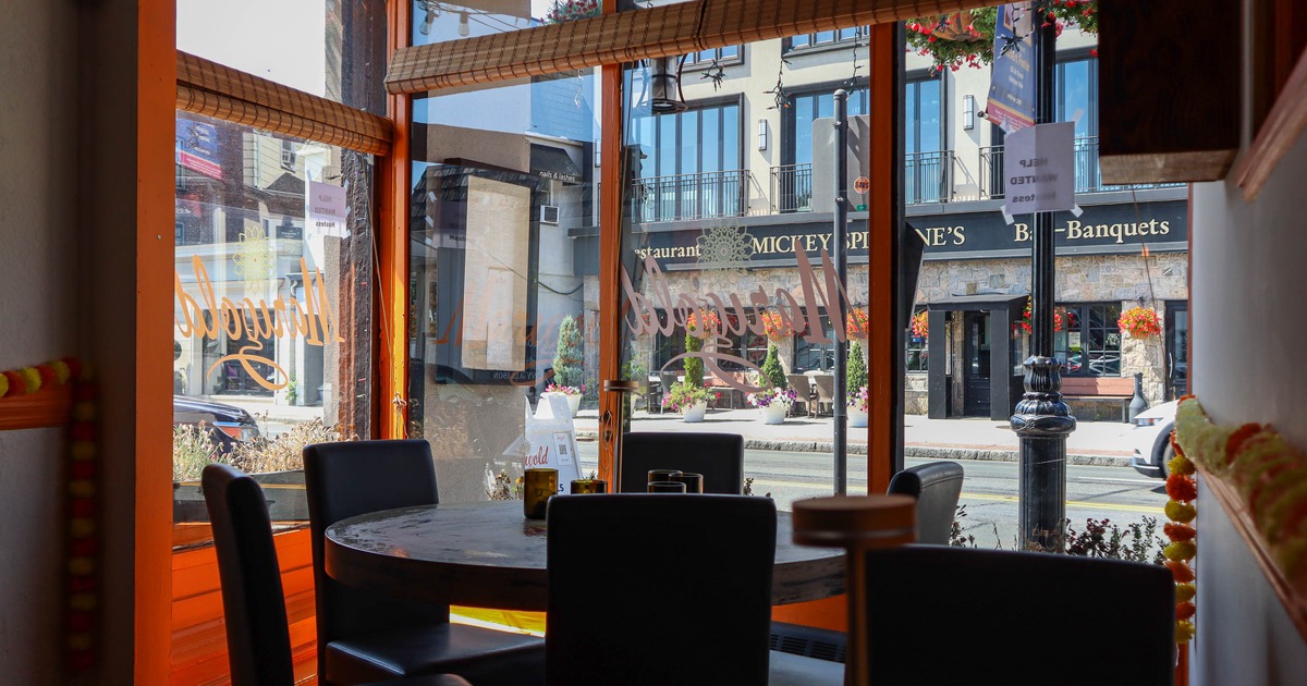 Round diner table by side walk window