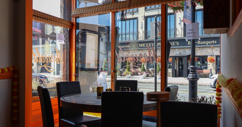 Round diner table by side walk window