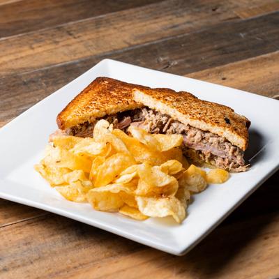 Cuban Sandwich with potato chips.