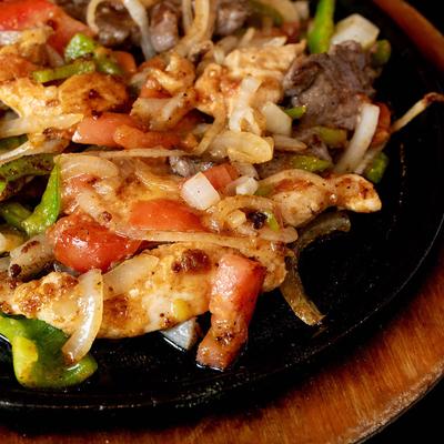 Close up of chicken and steak fajitas.
