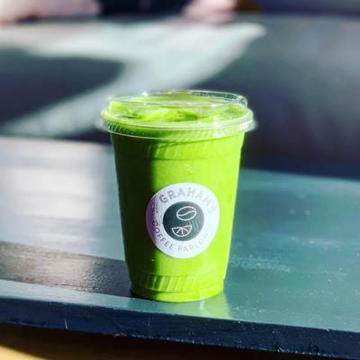 Iced matcha latte in a plastic cup labeled with Graham's Coffee Parlor.