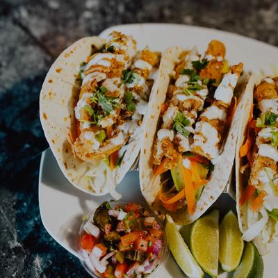 Fried chicken tacos served with pico de gallo.