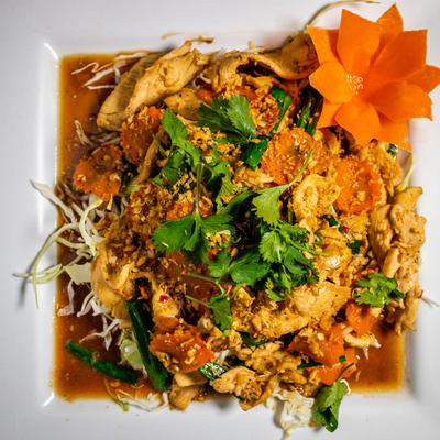 Dish of stir fried meat, garlic pepper sauce, fresh and fried vegetables