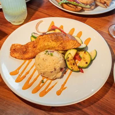Cajun Salmon served with vegetables and mashed potatoes.