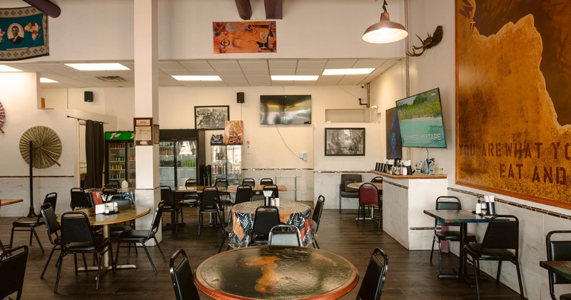 Interior seating area with tables and black chairs