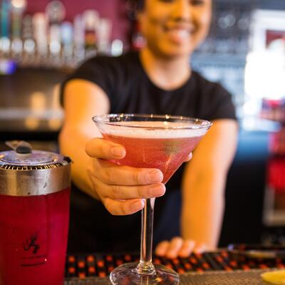 Staff member making martini