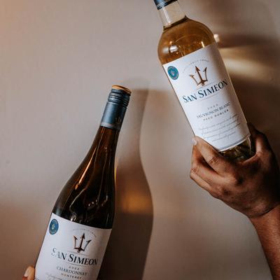 Hands holding bottles.