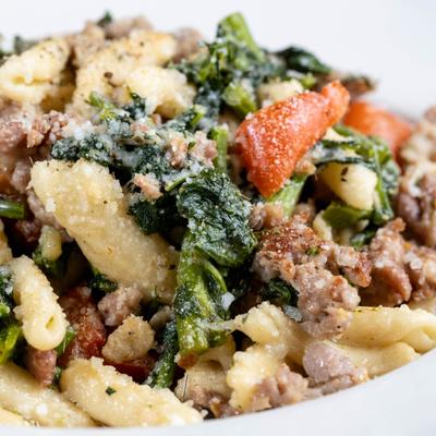 Cavatelli pasta with broccoli rabe, crumbled sausage, bell peppers, garlic, and oil.