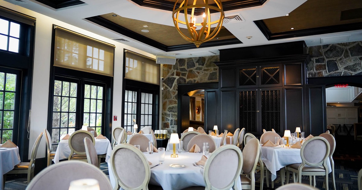 Interior, dining area, tables for four and six, stone decorated walls, carpet flooring